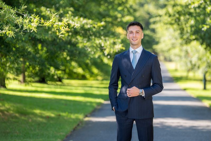 Adam Pavlou, Ray White real estate agent, on a tree lined street in Melbourne's inner east