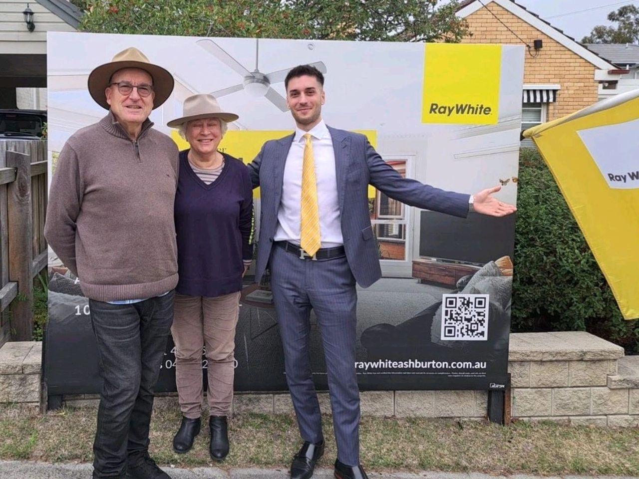 Sold off market — Pavlou Brothers result Vendors beside a Ray White sold board after a quiet off market sale in Melbourne